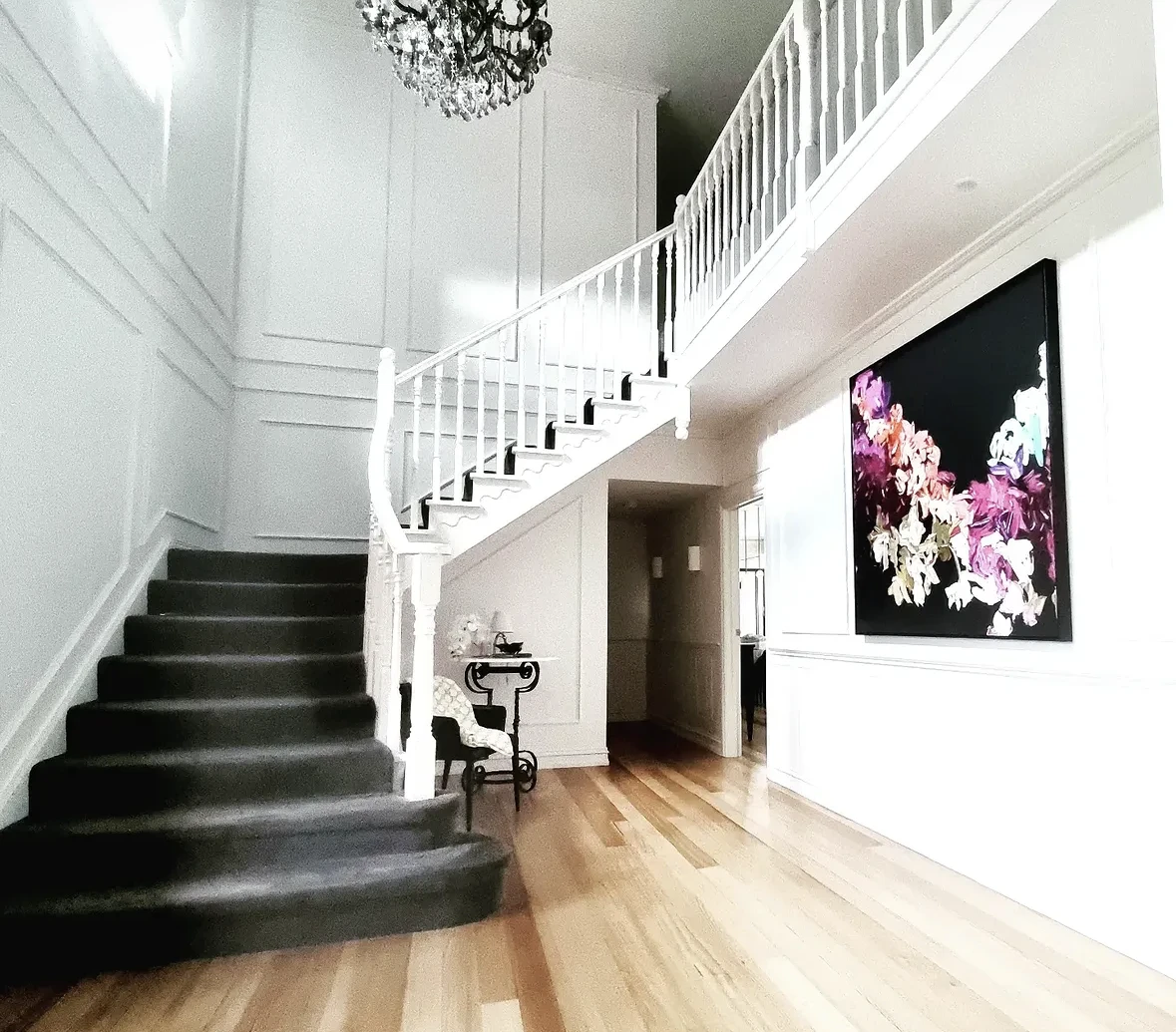 Painted white stair balustrades and panelled walls in the East Keilor home revisited for maintenance